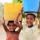 Local children carrying water