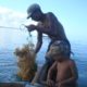 seaweed farmer and his son